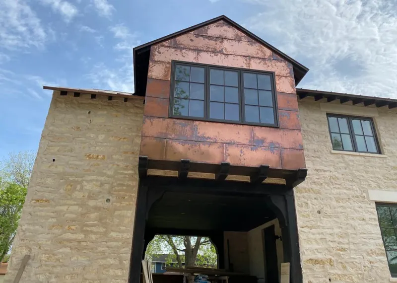Copper metal panel facade on a stone building for Skylight Installation in Blackhawk