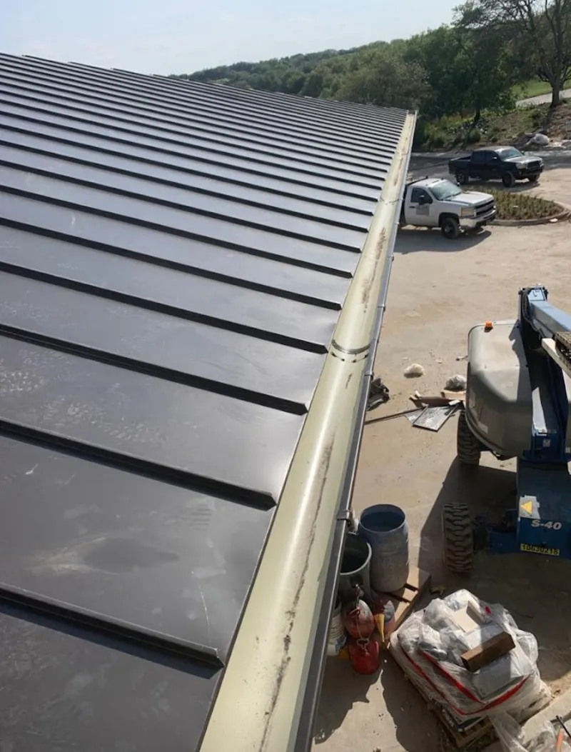 Standing seam panel and gutter detail on a metal roofing jobsite in Blackhawk